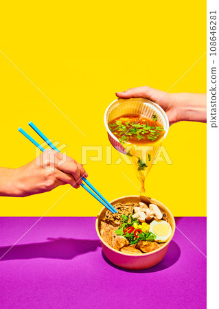 Stir-fry soba in trendy style. Hand pouring broth to fried noodles, Asian fried buckwheat noodles with chicken on vivid background. 108646281
