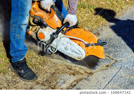 Road restoration cutting damaged asphalt cracks before installing new asphalt Road restoration cutting damaged asphalt cracks before installing new asphalt 108647142