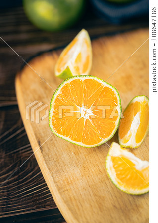 Oranges placed on a wooden board 108647186