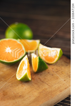 Oranges placed on a wooden board 108647194