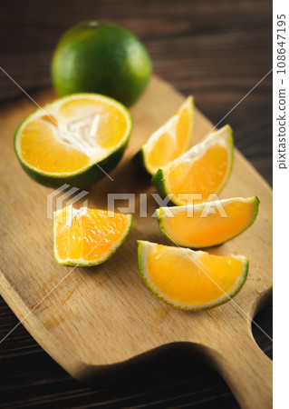 Oranges placed on a wooden board 108647195