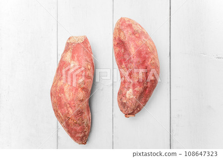 Sweet potatoes placed on a white wooden board. 108647323