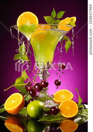 cocktail with fruits and water splashes, on color background, fresh and healthy food 108647464