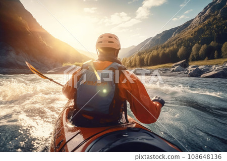 Man kayak down a wide mountain river among beautiful forests and mountains. Colorful landscape in the rays of the sun during sunrise or sunset. Man kayak down a wide mountain river among beautiful forests and mountains. Colorful landscape in the rays of the sun during sunrise or sunset. 108648136