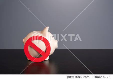 Piggy bank under the symbol of prohibition. Sanctions. Capital outflow restrictions. Freezing savings. Lack of funds. Refusal of savings in favor of investments. Piggy bank under the symbol of prohibition. Sanctions. Capital outflow restrictions. Freezing savings. Lack of funds. Refusal of savings in favor of investments. 108648272