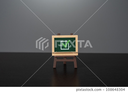 Chalk board with green check mark. Election concept. Voting and politics. Removing restrictions and granting permits. Fulfill all requirements. Reach the goal. Chalk board with green check mark. Election concept. Voting and politics. Removing restrictions and granting permits. Fulfill all requirements. Reach the goal. 108648304