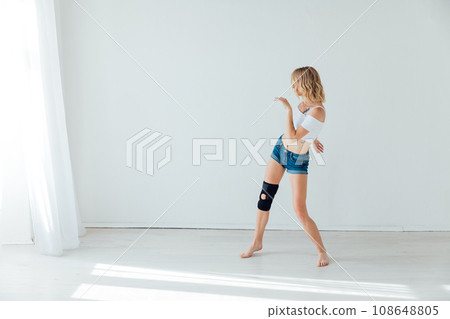 Slender woman dancing in bright studio 108648805