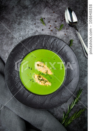 creamy broccoli soup with meat and dill in a black plate 108648838
