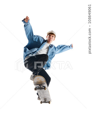 Sportive, active young man in casual clothes in motion, training with skateboard, doing stunts isolated over white background 108649061