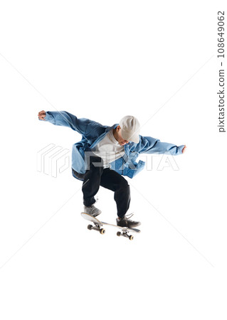 Dynamic image of young man in casual clothes in motion, training, skateboarding isolated over white background 108649062
