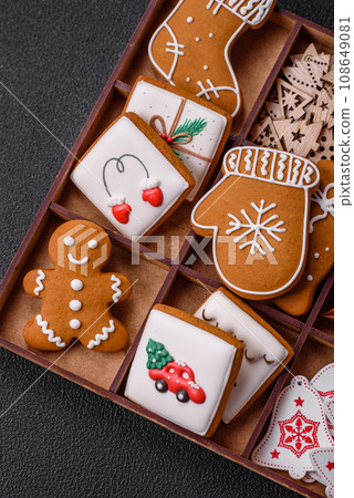 Beautiful Christmas gingerbread cookies of different colors on a ceramic plate Beautiful Christmas gingerbread cookies of different colors on a ceramic plate 108649081