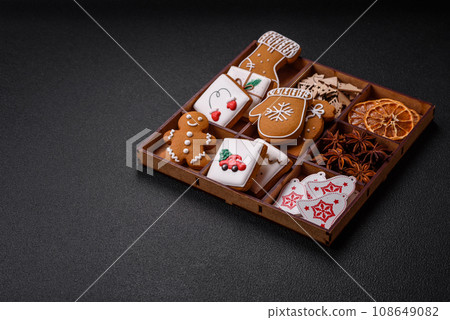 Beautiful Christmas gingerbread cookies of different colors on a ceramic plate 108649082