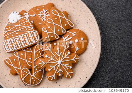 Beautiful Christmas gingerbread cookies of different colors on a ceramic plate 108649170