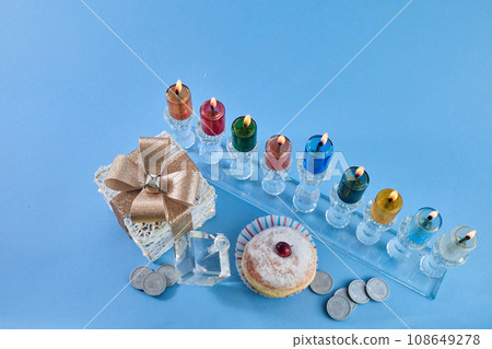 Jewish holiday Hanukkah with menorah, traditional Candelabra, donut and dreidel, spinning top. 108649278