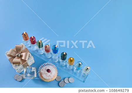 Jewish holiday Hanukkah with menorah, traditional Candelabra, donut and dreidel, spinning top. Jewish holiday Hanukkah with menorah, traditional Candelabra, donut and dreidel, spinning top. 108649279