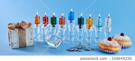 Jewish holiday Hanukkah with menorah, traditional Candelabra, donut and dreidel, spinning top. Jewish holiday Hanukkah with menorah, traditional Candelabra, donut and dreidel, spinning top. 108649288
