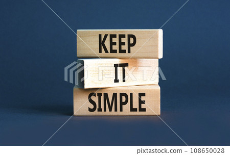 Keep it simple symbol. Concept word Keep it simple on beautiful wooden block. Beautiful grey table grey background. Business motivational keep it simple concept. Copy space. 108650028