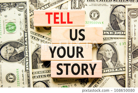 Tell us your story symbol. Concept word Tell us your story on beautiful wooden block. Dollar bills. Beautiful background from dollar bills. Business tell us your story concept. Copy space. 108650080