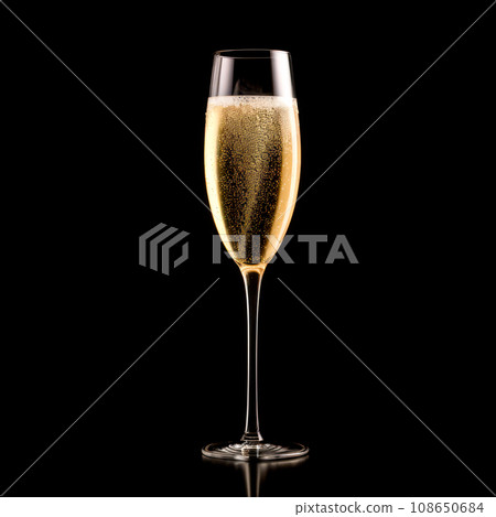 A crystal-clear flute glass of champagne isolated on black background A crystal-clear flute glass of champagne isolated on black background 108650684