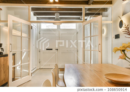a kitchen and dining area in a tiny house with white walls, wood flooring and exposed ceiling fan mounted on the wall a kitchen and dining area in a tiny house with white walls, wood flooring and exposed ceiling fan mounted on the wall 108650914