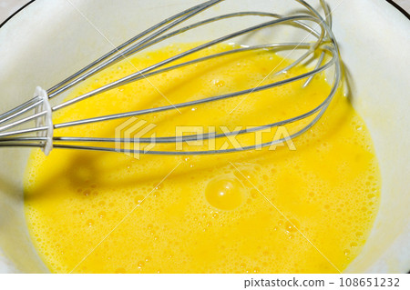 Whipped egg yolks in an iron bowl Whipped egg yolks in an iron bowl 108651232