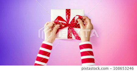 Person making a Christmas gift box 108653246