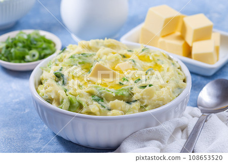 Delicious homemade Irish dish Colcannon or mashed potato with green cabbage and butter, horizontal 108653520
