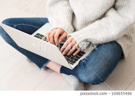 Young woman operating a laptop, lifestyle image Young woman operating a laptop, lifestyle image 108655486