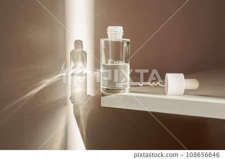 A transparent bottle of serum under the morning sun. A transparent bottle of serum under the morning sun. 108656646
