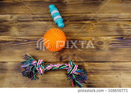 Dog's toys on a wooden background. Top view 108656771