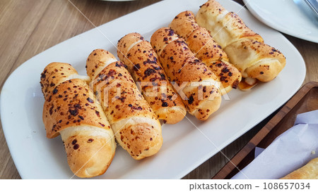 Delicious baked cheese rolls, baked crunchy cheese bread on an catering event, selected focus, cheese wrapped in bread and baked 108657034