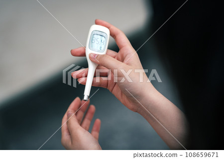 A woman measuring body temperature 108659671