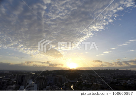 Clouds and sunrise over the city 108660897