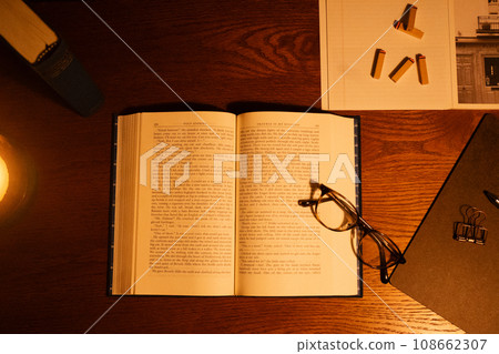 open book and glasses on the table open book and glasses on the table 108662307