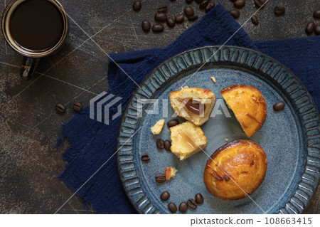 Pasticciotto leccese pastries on a plate near coffe cup and moka on dark table top view Pasticciotto leccese pastries on a plate near coffe cup and moka on dark table top view 108663415