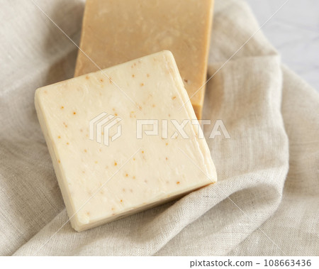 Beige handmade soap bars on cream linen towel close up 108663436