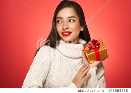 Beautiful in a white knitted sweater with gift box 108663518