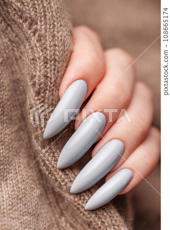 Woman's hand with grey nail polish Woman's hand with grey nail polish 108665174