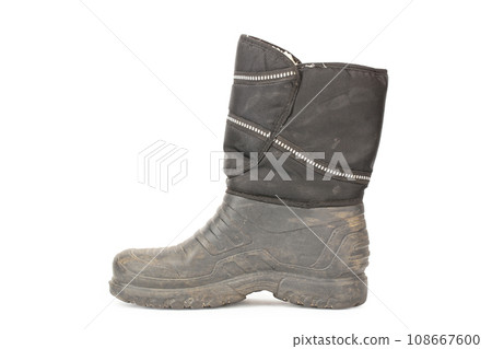 One dirty male rubber boot. isolated on white background. autumn rain protection shoes. 108667600