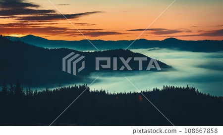 Sunrise sea of fog moving over mountain range silhouette with pine tree forest aerial view. Wild nature mist landscape. Dramatic dark clouds float in orange colored sky 108667858