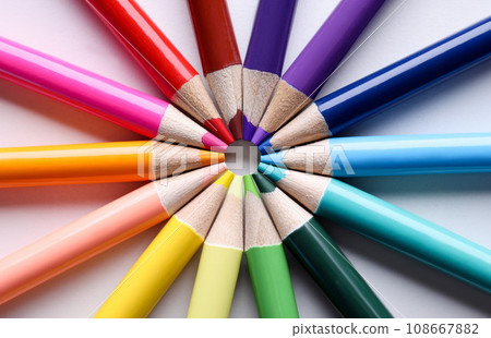 Multicolored pencils lying in shape of sun closeup 108667882