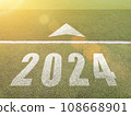 New year 2024. Text of 2024 has written on the ground. Straight forward concept. Keep going to the goal. target and challenge. 108668901