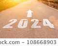 New year 2024. Text of 2024 has written on the ground. Straight forward concept. Keep going to the goal. target and challenge. 108668903