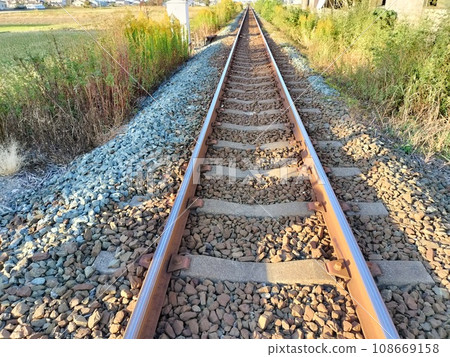 Scenery of train tracks stretching in a straight line Scenery of train tracks stretching in a straight line 108669158