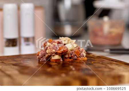 slices of fresh raw meat and potatoes on wooden cutting board slices of fresh raw meat and potatoes on wooden cutting board 108669525