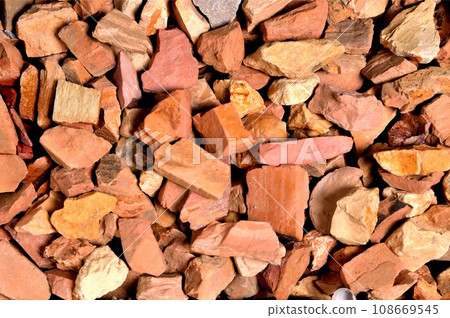 small non-uniform stones of red-pink color with rectangular faces, background, texture 108669545