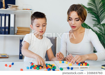 female psychologist develops boy fine motor skills development learning 108669760
