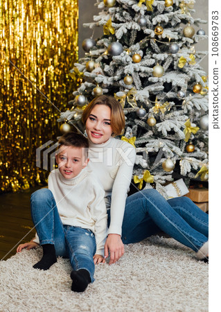 holiday mother and son sit by the tree new year christmas holiday mother and son sit by the tree new year christmas 108669783