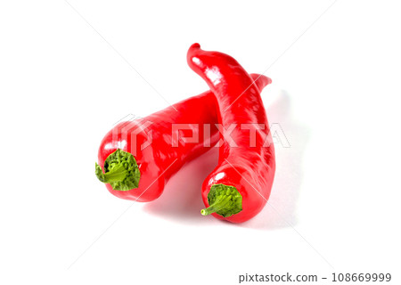 two red peppers elongated shape on white background, isolate 108669999