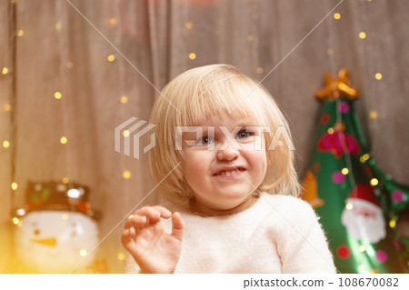 Portrait of two year old little Christmas blonde girl with blue eyes 108670082